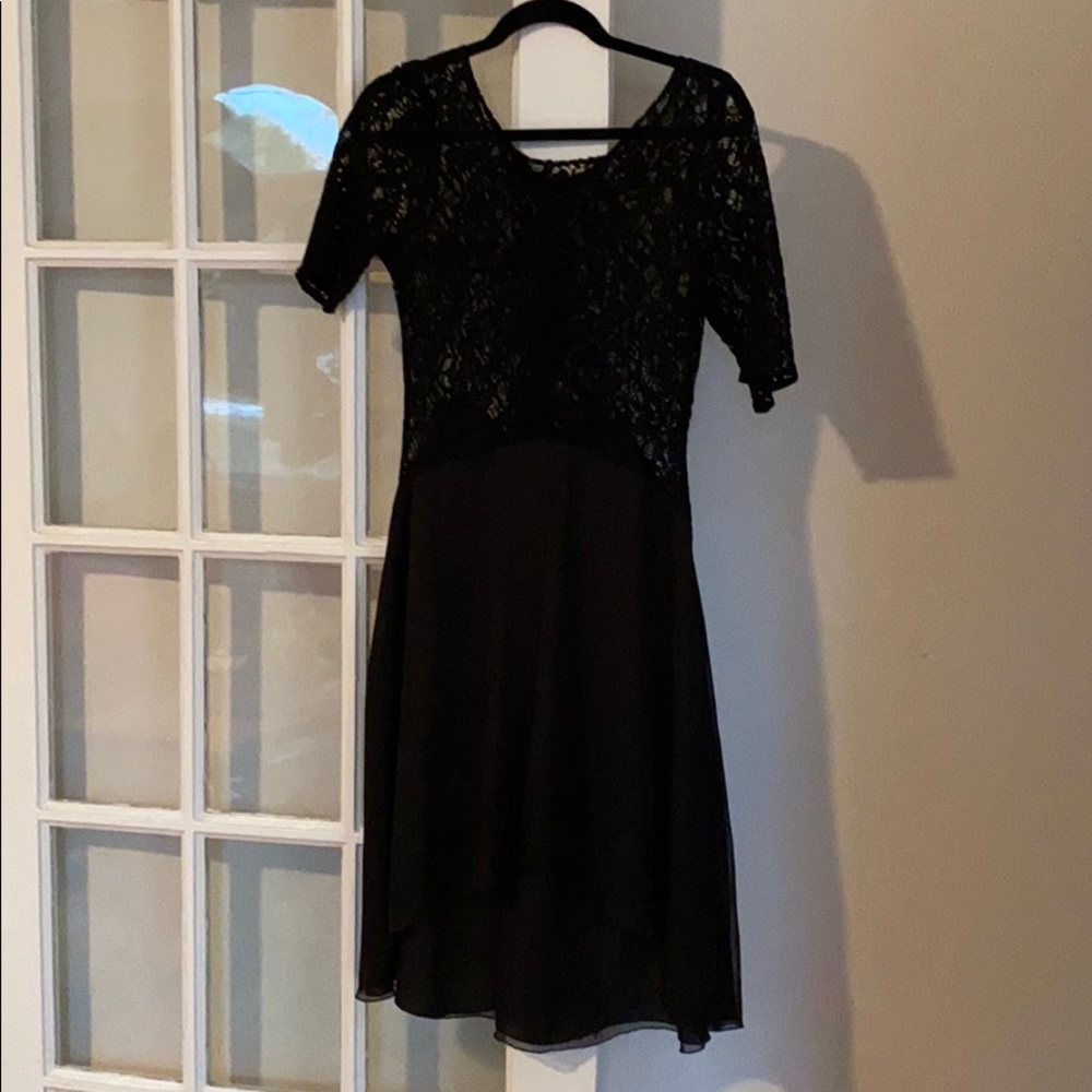 Beautiful black dress. Lower in the front. Zipper.